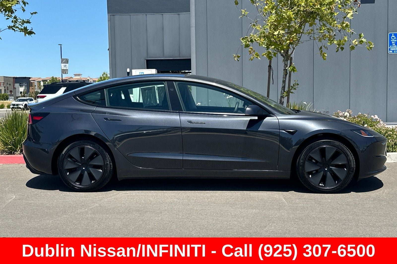 2025 Tesla Model 3 — rear three-quarter view